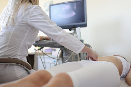 Doctor making ultrasound examination of pelvic organs to woman patient closeup
