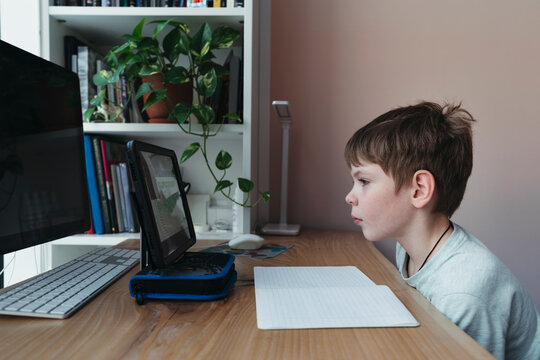 Quarantined Young Schoolboy Studies From Home.
