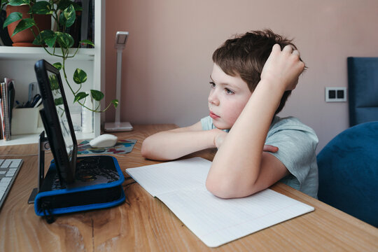 Quarantined Young Schoolboy Studies From Home.