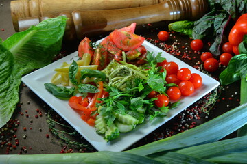 Spaghetti with green asparagus, cherry tomatoes and fresh basil. Italian food. Italian pasta. Symbolic image. Concept for a tasty and healthy vegetarian dish.
