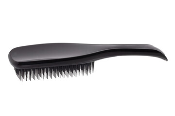 Closeup of a stylish new black hair brush isolated on white background. Concept of body and beauty care. Macro.