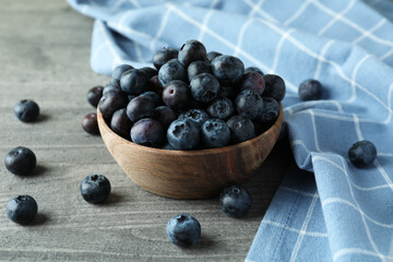 Bowl of fresh blueberry on gray textured background