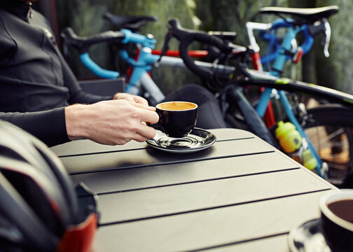 Male Road Cyclist stops for coffee mid ride 