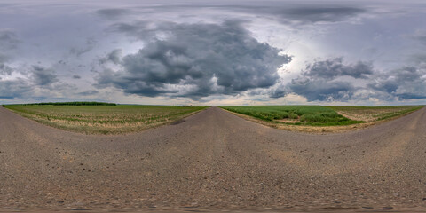 Full spherical seamless panorama 360 degree angle view on no traffic old asphalt road among fields...