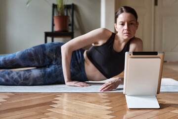 Young woman doing exercises online
