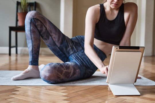 Young woman doing exercises online