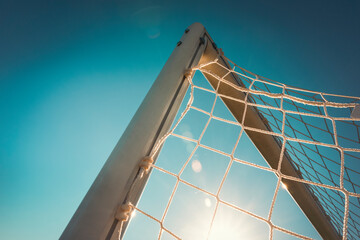 Top corner of a football goal in the sunset