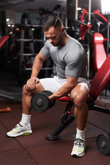 Fototapeta na wymiar Bodybuilder doing biceps workout
