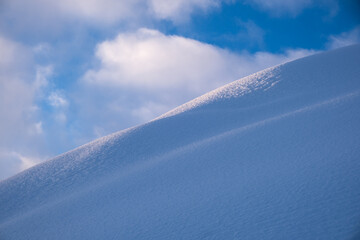 snow dune and puffy cloud