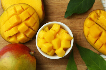 Tasty ripe mango fruit on wooden table
