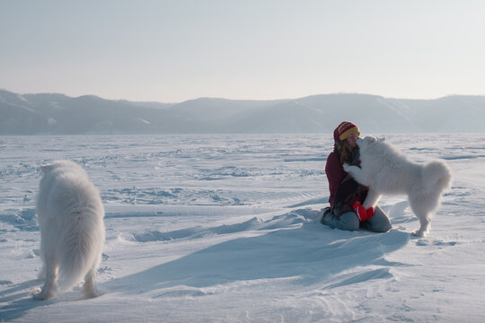 wintertime fun: young woman and her two dogs