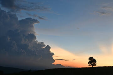 the background of the sunset in the sky with big clouds
