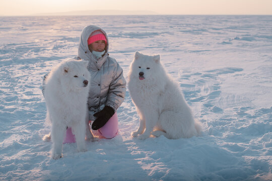 wintertime fun: young woman and her two dogs