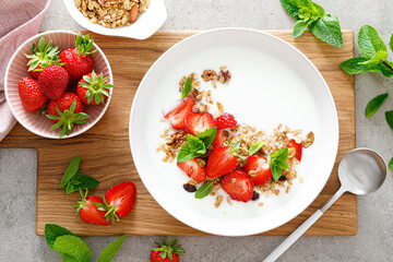 Strawberry granola with greek yogurt, nuts and fresh berries for breakfast, top view