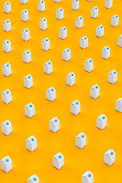 pattern of blue packaging containers on orange background - vertical image
