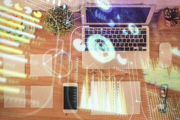 Multi exposure of data theme drawing hologram over topview work desk background with computer. Concept of technology.
