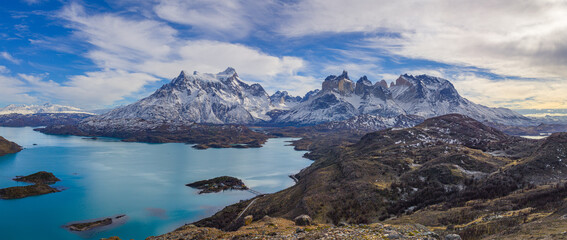 Winter in Patagonia: aerial view of a landscape with the lake Lago Pahoe and the snow covered Paine mountain range - obrazy, fototapety, plakaty