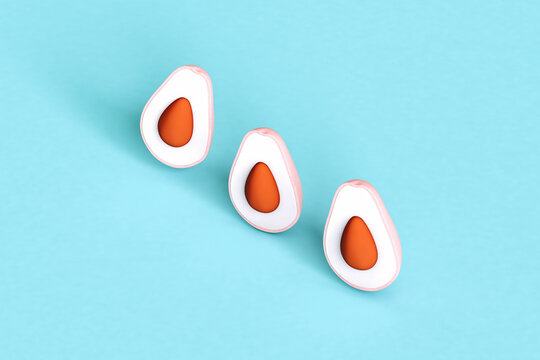 three Pink avocados on blue background
