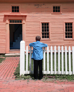 Boy Looking at Old House