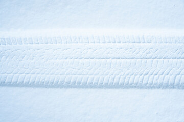 Tire trace in the snow. Winter tires or winter driving background.