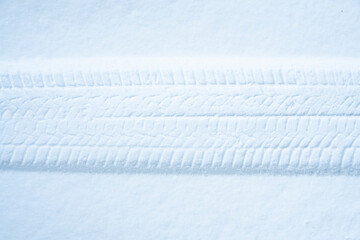 Tire trace in the snow. Winter tires or winter driving background.