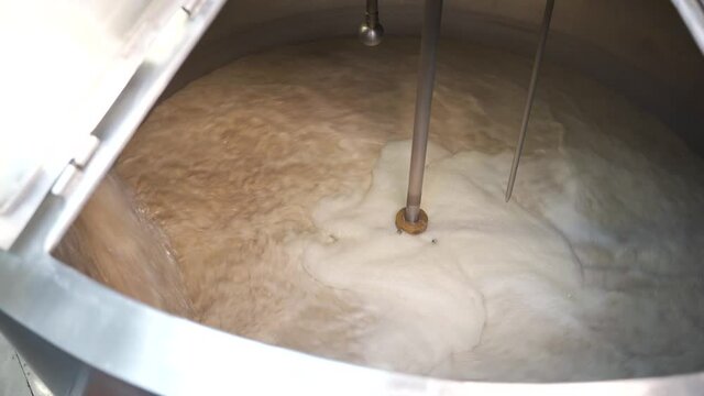 Brewing. Beer in the tank for brewing whirls in a whirlpool, mixed. The process of making beer.