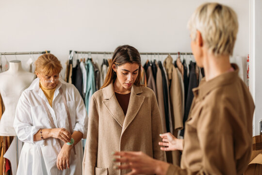 A Woman Fitting a Coat 