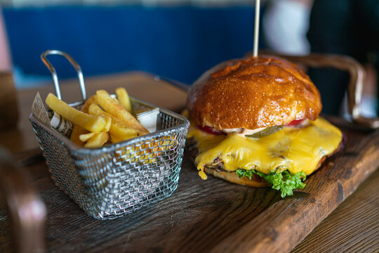 Tasty big burger on wooden table. juicy burger and fries