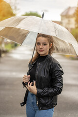 Young girl holding an umbrella in the rain © Bedo