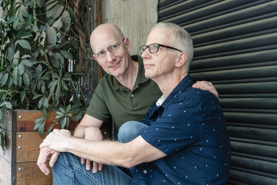 Gay couple sitting at the porch