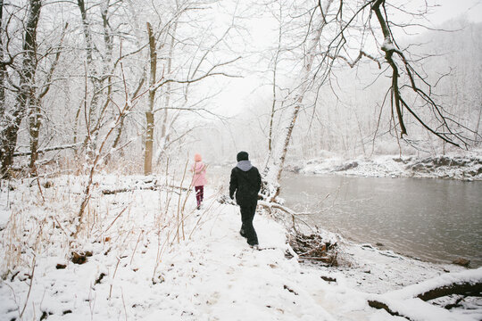 kids walk in snowy woods