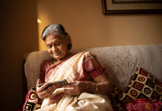 Active senior browsing internet with smartphone