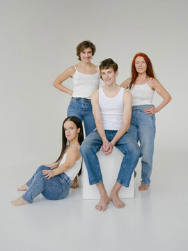 Group of diverse people in similar outfits in studio