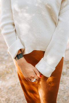 Midsection of a woman wearing knitted cashmere sweater and a sil
