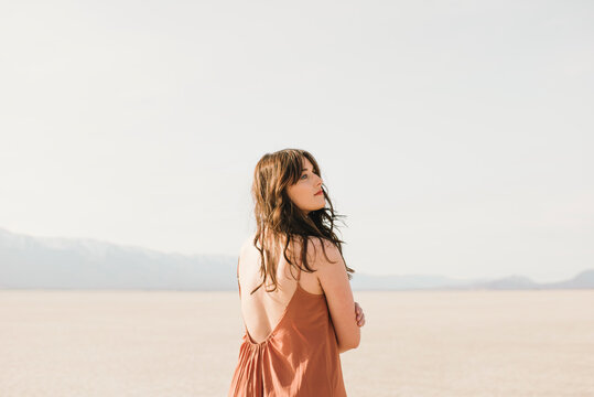 Young Woman In A Dress Standing In The Desert