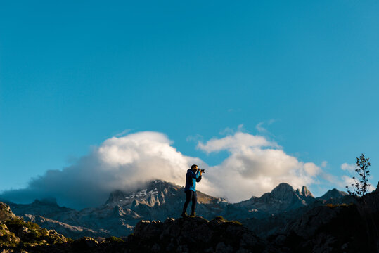 Photographer on top of a cliff taking photos