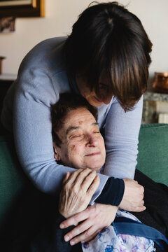 Woman hugging an elderly lady