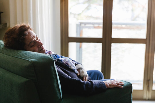 Old Woman Sleeping On The Armchair