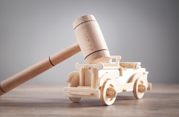 Wooden toy car and judge gavel.