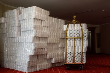 Many rolls of toilet paper in a hotel trolley.