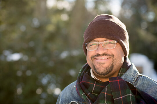 Smiling Black man in glasses and scarf