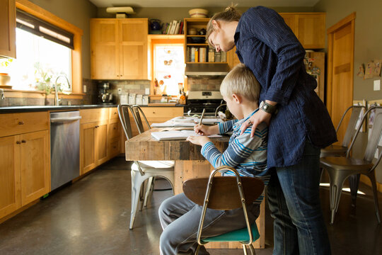 Mother looks at son's schoolwork