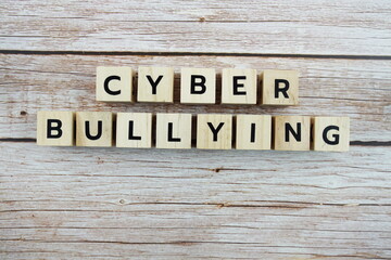 Cyber Bullying word alphabet letters on wooden background