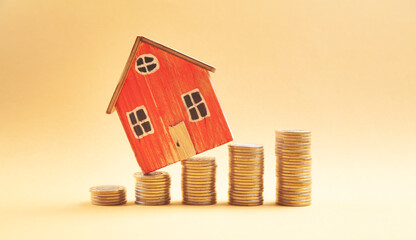  Stack of coins and house model. Saving money for buy a house