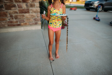 Girl in swimsuit eating cake. 