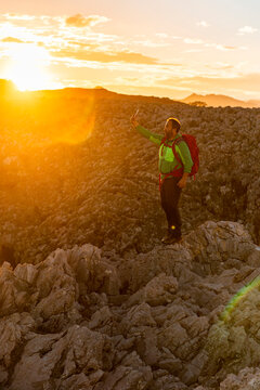 Backpacker taking selfie in mountains at sunset  