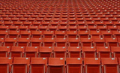 Fototapeta premium the emptiness of the seats in the football stadium,Red seats in a closed football stadium
