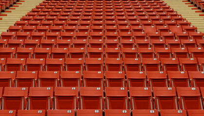seat in a football field where no one is allowed to enter,Red chairs for watching football matches