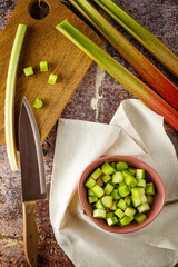 still life with fresh organic rhubarb on wooden background