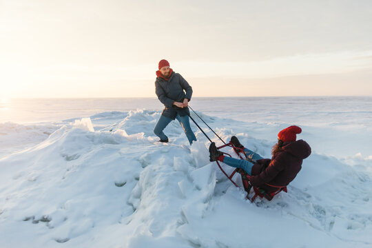 couple having fun with a sled
